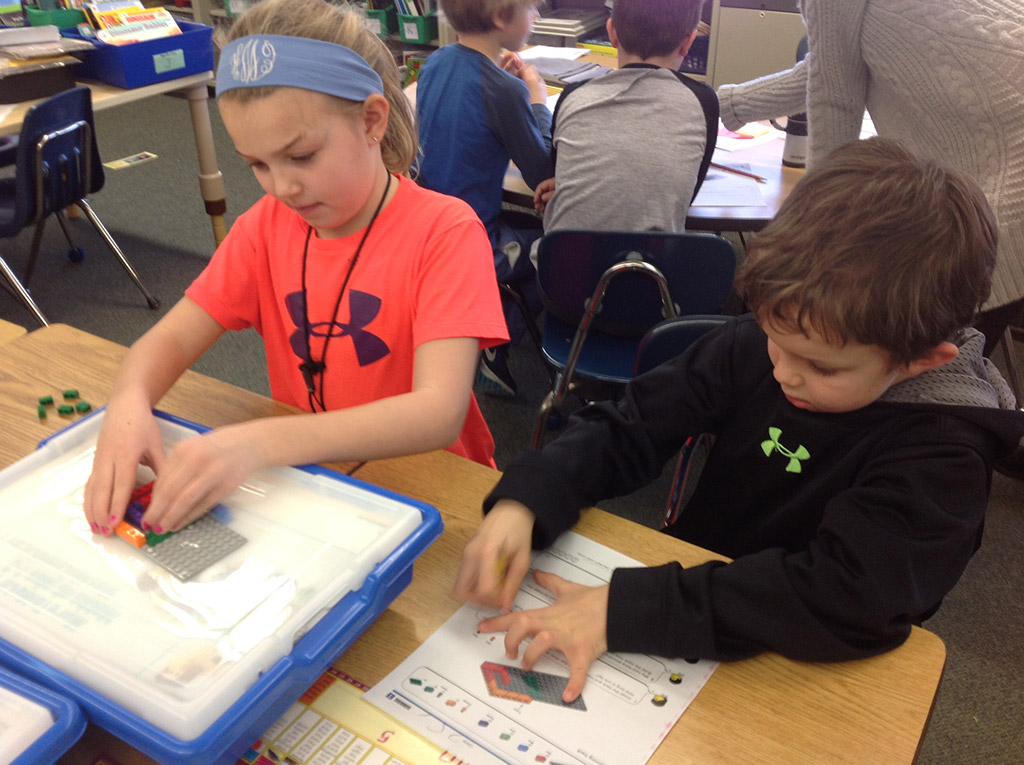 Students building a Lego kit
