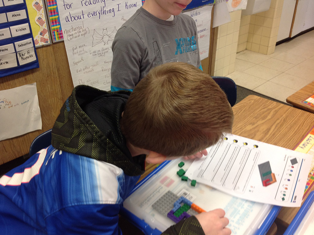 Students building a Lego kit