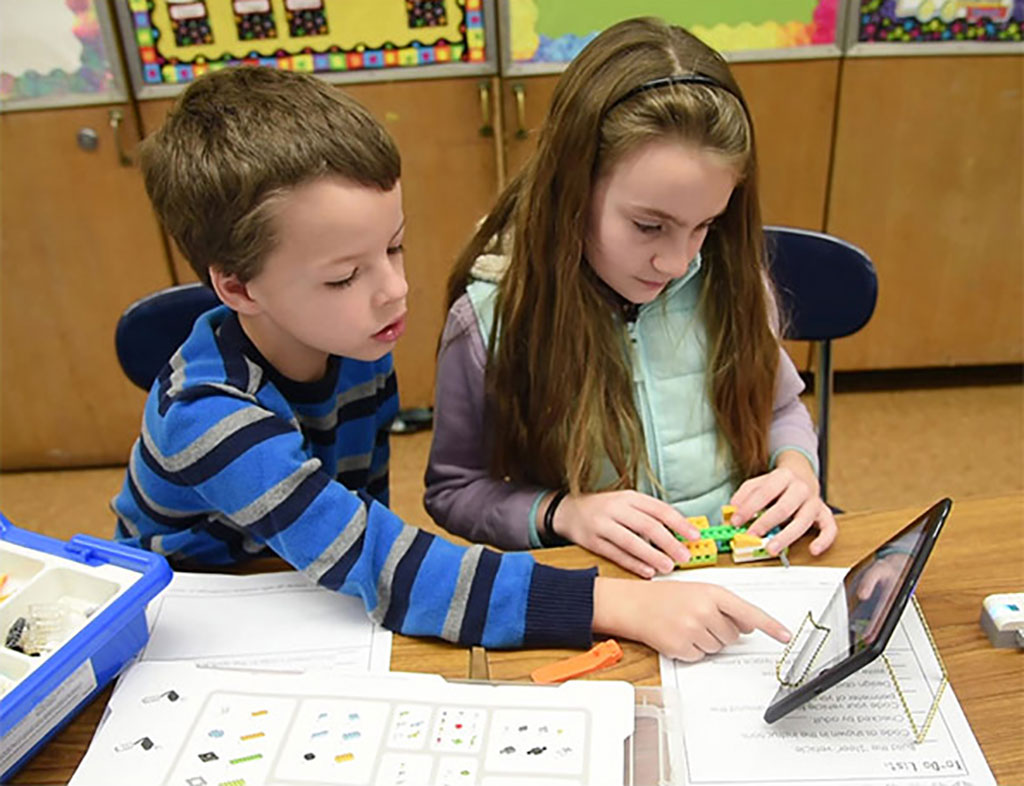 Two students reading on a tablet