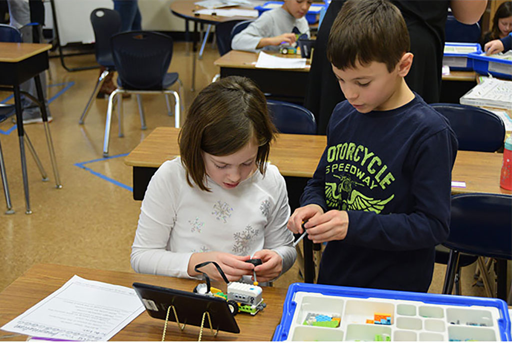 Two students building a robot