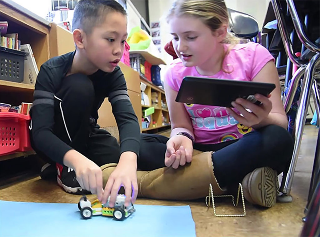 Two students building a robot