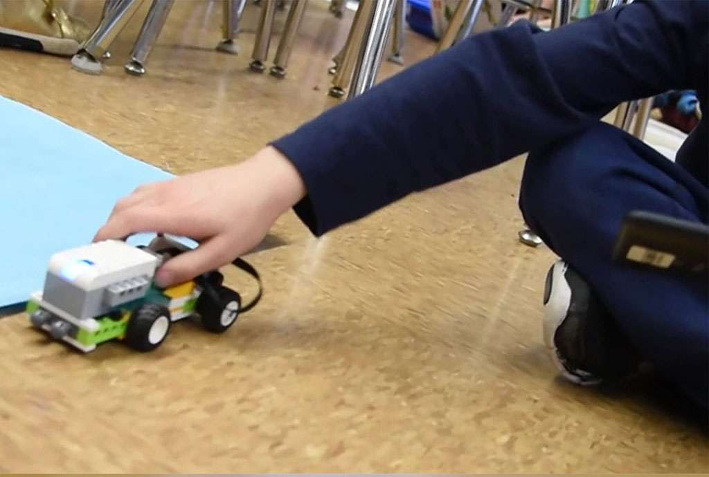 Student pushing their robot car