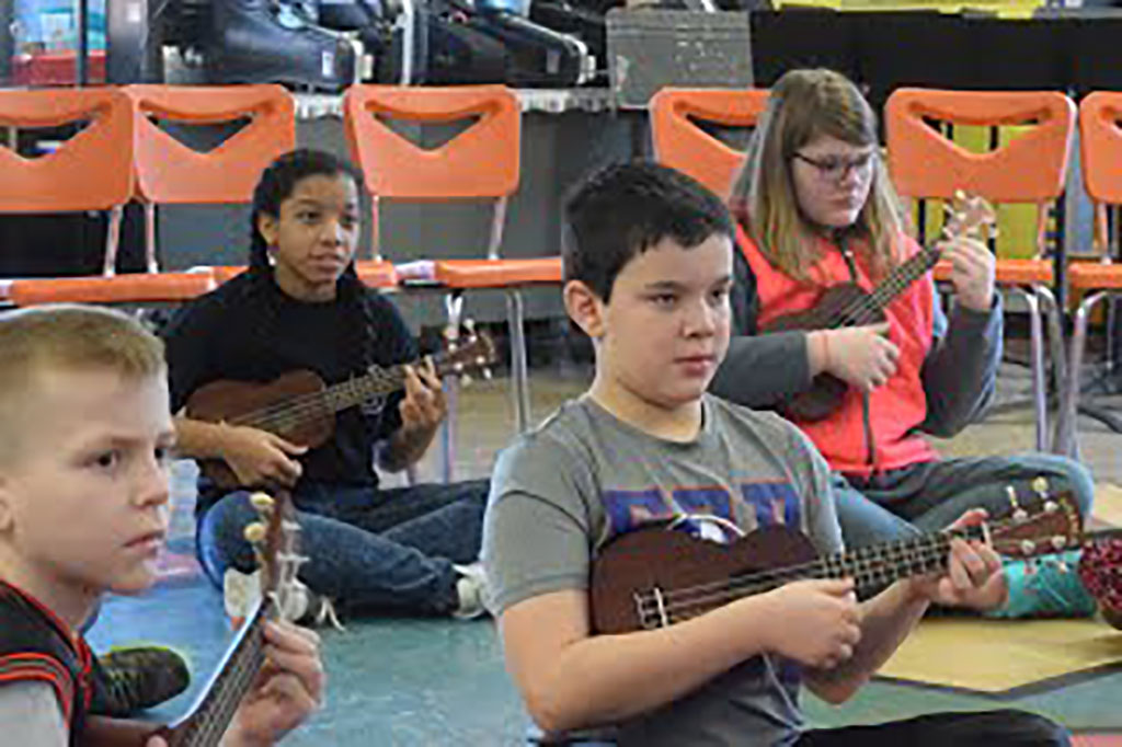 Students playing ukuleles