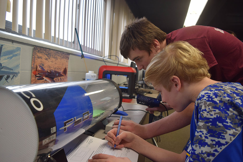 Students observing a wind tunnel